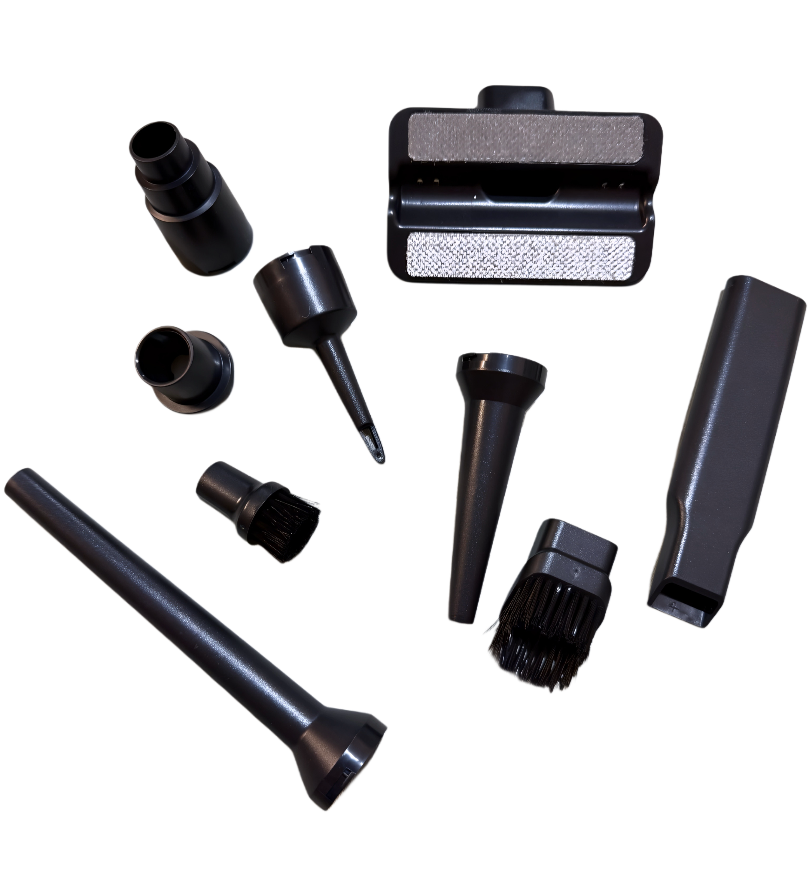 A set of multi-purpose vacuum attachments displayed next to the cordless handheld vacuum, including precision nozzles for tight spaces and vents.